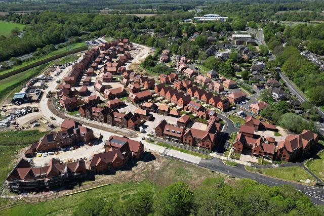 An aerial view shows ongoing construction of new build homes, some with solar panels on their roofs in Send, south of London on April 30, 2026. The Bank of England on April 30 left its benchmark interest rate unchanged at 3.75 percent, but signalled hikes could be needed if the Middle East war continues to drive up inflation. (Photo by Justin TALLIS / AFP)