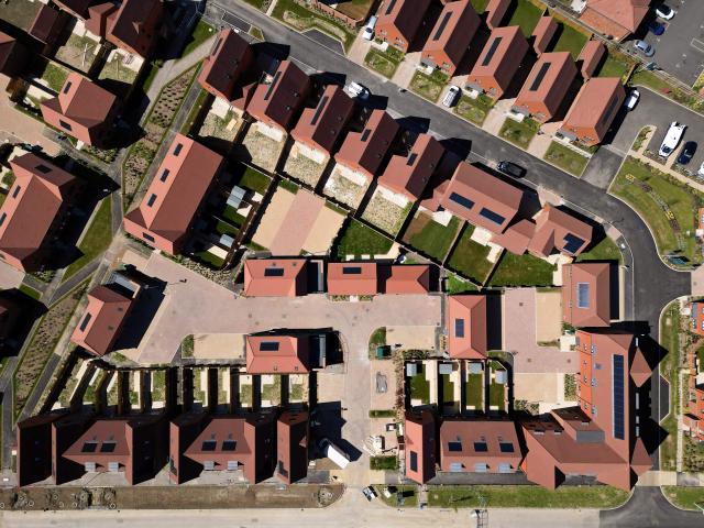 An aerial view shows ongoing construction of new build homes, some with solar panels on their roofs in Send, south of London on April 30, 2026. The Bank of England on April 30 left its benchmark interest rate unchanged at 3.75 percent, but signalled hikes could be needed if the Middle East war continues to drive up inflation. (Photo by Justin TALLIS / AFP)