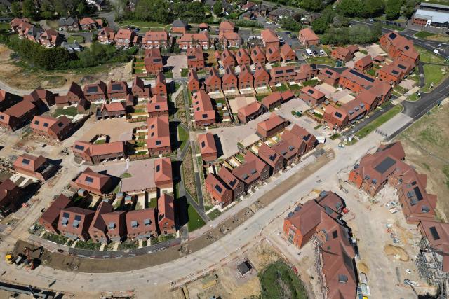 An aerial view shows ongoing construction of new build homes, some with solar panels on their roofs in Send, south of London on April 30, 2026. The Bank of England on April 30 left its benchmark interest rate unchanged at 3.75 percent, but signalled hikes could be needed if the Middle East war continues to drive up inflation. (Photo by Justin TALLIS / AFP)