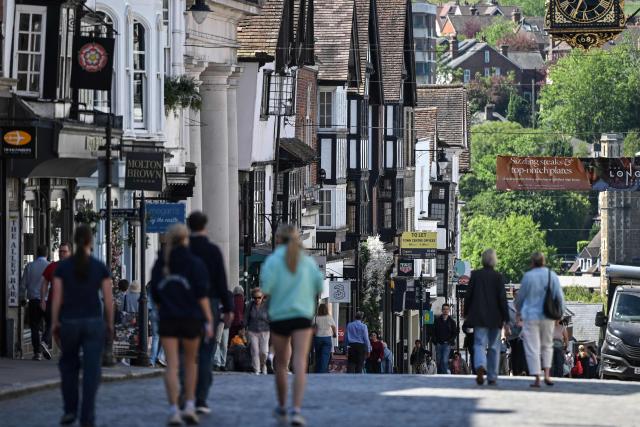Pedestrians make their way down the high street in Guildford, south of London on April 30, 2026. The Bank of England on April 30 left its benchmark interest rate unchanged at 3.75 percent, but signalled hikes could be needed if the Middle East war continues to drive up inflation. (Photo by JUSTIN TALLIS / AFP)