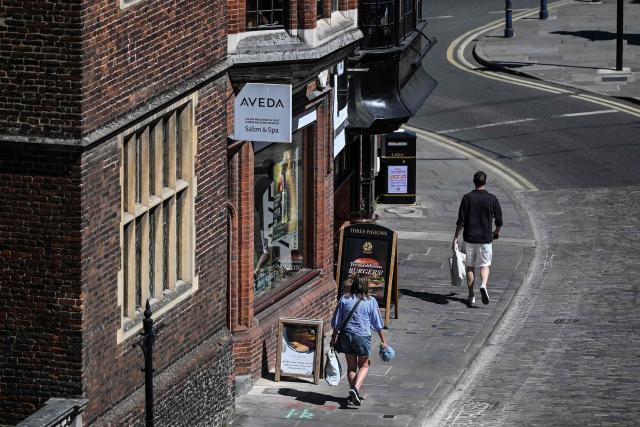 Pedestrians make their way down the high street in Guildford, south of London on April 30, 2026. The Bank of England on April 30 left its benchmark interest rate unchanged at 3.75 percent, but signalled hikes could be needed if the Middle East war continues to drive up inflation. (Photo by JUSTIN TALLIS / AFP)