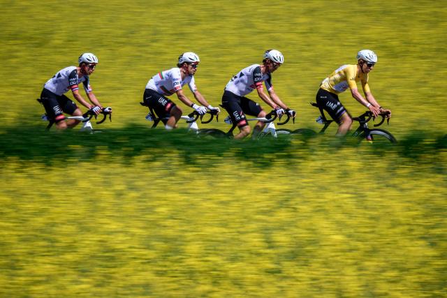 (From L) UAE Team Emirates XRG’s Slovenian rider Domen Novak, UAE Team Emirates XRG’s Portuguese rider Ivo Oliveira, UAE Team Emirates-XRG's Austrian rider Felix Grossschartner and UAE Team Emirates-XRG's Slovenian rider Tadej Pogacar ride next to rapeseed fields during the  second stage of the Tour of Romandie UCI cycling World tour, 173.1 km from Rue to Vucherens, near Vulliens, on April 30, 2026.  (Photo by Fabrice COFFRINI / AFP)