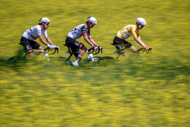 (From L) UAE Team Emirates XRG’s Portuguese rider Ivo Oliveira, UAE Team Emirates-XRG's Austrian rider Felix Grossschartner and UAE Team Emirates-XRG's Slovenian rider Tadej Pogacar ride next to rapeseed fields during the second stage of the Tour of Romandie UCI cycling World tour, 173.1 km from Rue to Vucherens, near Vulliens, on April 30, 2026.  (Photo by Fabrice COFFRINI / AFP)