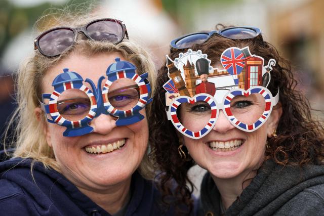 BritaGinny Musil (L) and Stacie Mikels both of Front Royal, Va poses for a photo wearing decorative glasses during a parade and block party on day four of the state visit of King Charles III and Queen Camilla on April 30, 2026 in Front Royal, Virginia. (Photo by Win McNamee / POOL / AFP)
