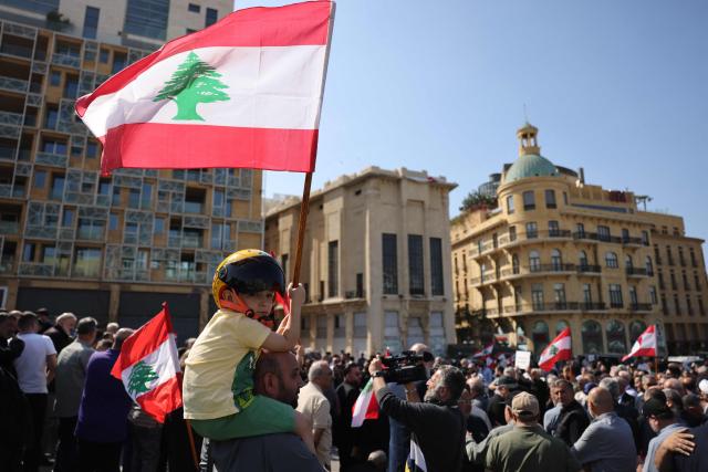A child waves a Lebanese flag while residents, mukhtars, and inhabitants of the devastated southern Lebanese border villages protest against the destruction of their villages and being prevented from returning by order of the Israeli army, at Martyrs Square in central Beirut on April 30, 2026. On April 30, an Israeli army spokesperson called for the evacuation of eight southern villages ahead of planned military action there. Shortly after the ceasefire began on April 17, Israel declared a so-called "Yellow Line", a strip of Lebanese territory about 10 kilometres deep along the border, where it has been operating and demolishing villages. (Photo by Anwar AMRO / AFP)