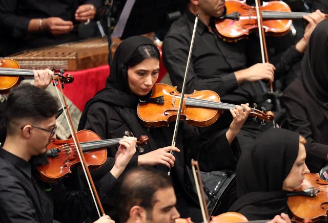 Members of Iran's National Music Orchestra perform on the occasion of the national "Persian Gulf" day at the Vahdat Hall in Tehran, on April 30, 2026. Iran's parliament speaker Mohammad Bagher Ghalibaf vowed on April 30 that his country's control over the strategic Strait of Hormuz would ensure a future without US presence in the area. "Today, by managing the Strait of Hormuz, Iran will provide itself and its neighbours with the precious blessing of a future free from American presence and interference," said Ghalibaf in a post on X to mark the national "Persian Gulf" day. (Photo by AFP)