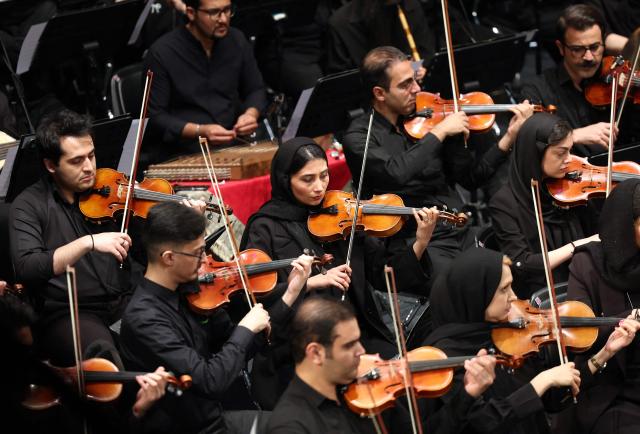 Members of Iran's National Music Orchestra perform on the occasion of the national "Persian Gulf" day at the Vahdat Hall in Tehran, on April 30, 2026. Iran's parliament speaker Mohammad Bagher Ghalibaf vowed on April 30 that his country's control over the strategic Strait of Hormuz would ensure a future without US presence in the area. "Today, by managing the Strait of Hormuz, Iran will provide itself and its neighbours with the precious blessing of a future free from American presence and interference," said Ghalibaf in a post on X to mark the national "Persian Gulf" day. (Photo by AFP)