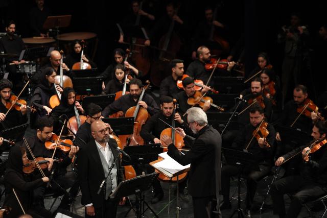 Permanent conductor of Iran's National Music Orchestra, Homayoun Rahimian leads a performance on the occasion of the national "Persian Gulf" day at the Vahdat Hall in Tehran, on April 30, 2026. Iran's parliament speaker Mohammad Bagher Ghalibaf vowed on April 30 that his country's control over the strategic Strait of Hormuz would ensure a future without US presence in the area. "Today, by managing the Strait of Hormuz, Iran will provide itself and its neighbours with the precious blessing of a future free from American presence and interference," said Ghalibaf in a post on X to mark the national "Persian Gulf" day. (Photo by AFP)