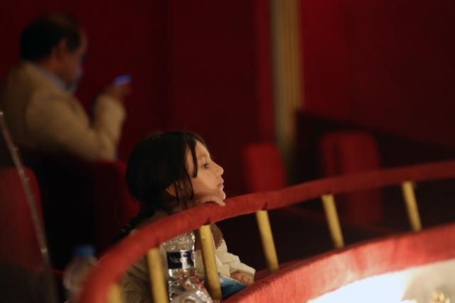 A girl watches as permanent conductor of Iran's National Orchestra, Homayoun Rahimian (unseen) leads a performance on the occasion of national "Persian Gulf" day at the Vahdat Hall in Tehran, on April 30, 2026. Iran's parliament speaker Mohammad Bagher Ghalibaf vowed on April 30 that his country's control over the strategic Strait of Hormuz would ensure a future without US presence in the area. "Today, by managing the Strait of Hormuz, Iran will provide itself and its neighbours with the precious blessing of a future free from American presence and interference," said Ghalibaf in a post on X to mark the national "Persian Gulf" day. (Photo by AFP)