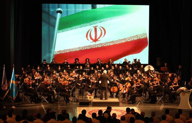 Permanent conductor of Iran's National Orchestra, Homayoun Rahimian leads a performance on the occasion of national "Persian Gulf" day at the Vahdat Hall in Tehran, on April 30, 2026. Iran's parliament speaker Mohammad Bagher Ghalibaf vowed on April 30 that his country's control over the strategic Strait of Hormuz would ensure a future without US presence in the area. "Today, by managing the Strait of Hormuz, Iran will provide itself and its neighbours with the precious blessing of a future free from American presence and interference," said Ghalibaf in a post on X to mark the national "Persian Gulf" day. (Photo by AFP)
