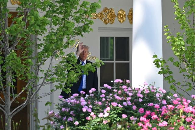 US President Donald Trump waves from outside the Oval Office after a formal farewell with Britain's King Charles III and Queen Camilla in Washington, DC, on April 30, 2026. King Charles III and Queen Camilla are wrapping up their visit to the United States and will head to Bermuda next. (Photo by Mandel NGAN / AFP)