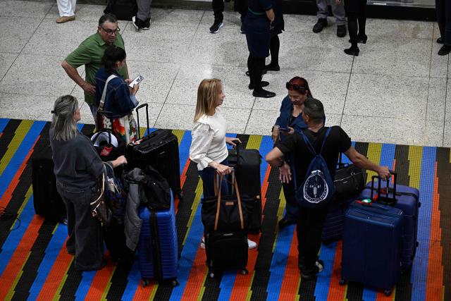 Passengers wait in line at the American Airlines check-in counters ahead of the arrival of a flight from Miami at Simon Bolivar International Airport in La Guaira, La Guaira state, Venezuela on April 30, 2026. The first direct flight between the United States and Venezuela in seven years took off on April 30, a new sign of a thaw after Washington deposed leftist leader Nicolas Maduro. (Photo by Federico PARRA / AFP)