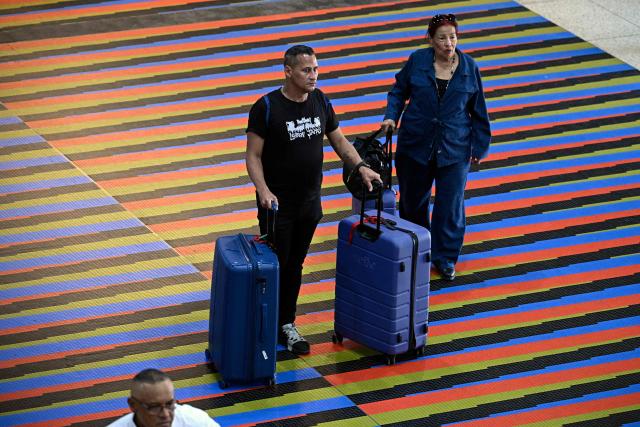 Passengers arrive at the American Airlines check-in counters ahead of the arrival of a flight from Miami at Simon Bolivar International Airport in La Guaira, La Guaira state, Venezuela on April 30, 2026. The first direct flight between the United States and Venezuela in seven years took off on April 30, a new sign of a thaw after Washington deposed leftist leader Nicolas Maduro. (Photo by Federico PARRA / AFP)