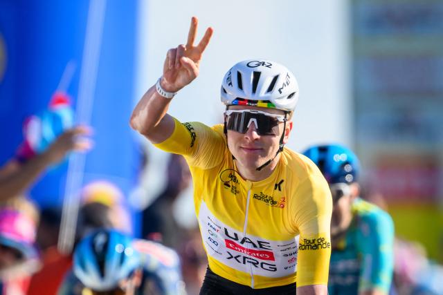 UAE Team Emirates-XRG's Slovenian rider Tadej Pogacar celebrates as he crosses the finish line of the second stage of the Tour of Romandie UCI cycling World tour, 173.1 km from Rue to Vucherens, in Vucherens, on April 30, 2026. (Photo by Fabrice COFFRINI / AFP)