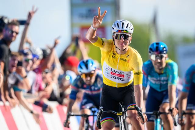 UAE Team Emirates-XRG's Slovenian rider Tadej Pogacar celebrates as he crosses the finish line of the second stage of the Tour of Romandie UCI cycling World tour, 173.1 km from Rue to Vucherens, in Vucherens, on April 30, 2026. (Photo by Fabrice COFFRINI / AFP)
