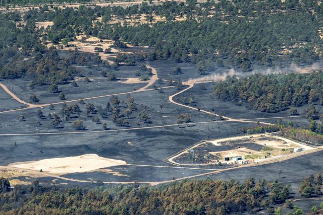 This photograph shows the site of a fire, a day after a fire tore through a military training camp in 't Harde village, eastern Netherlands on April 30, 2026. Local officials said the blaze began in the morning of April 29 at a firing range for the Dutch army's artillery in the village of 't Harde, forcing the temporary closure of part of the A28 motorway. (Photo by Bram van de Biezen / ANP / AFP) / Netherlands OUT