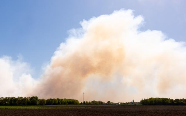 This photograph shows smoke from a wildfire rising over the Weerterheide in Limburg, southeastern Netherlands on April 30, 2026. (Photo by Iris van den Broek / ANP / AFP) / Netherlands OUT