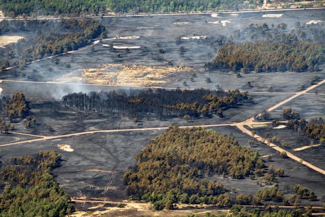 This photograph shows the site of a fire, a day after a fire tore through a military training camp in 't Harde village, eastern Netherlands on April 30, 2026. Local officials said the blaze began in the morning of April 29 at a firing range for the Dutch army's artillery in the village of 't Harde, forcing the temporary closure of part of the A28 motorway. (Photo by Bram van de Biezen / ANP / AFP) / Netherlands OUT