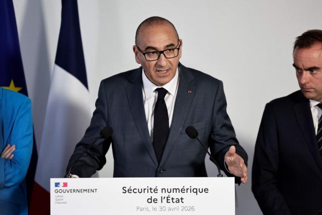 France's Interior Minister Laurent Nunez (C) speak flanked by France's Prime Minister Sebastien Lecornu (R) during a visit to the headquarters of the French National Agency for Secure Documents (Agence nationale des titres securises - ANTS), in Paris, on April 30, 2026. The National Agency for Secure Documents suffered a massive data breach on 15 April, 2026. The data of nearly 12 million individuals and businesses had been affected by the attack. (Photo by STEPHANE DE SAKUTIN / AFP)
