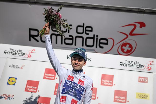 Bahrain Victorious’ French rider Lenny Martinez wearing the best young rider's white jersey celebrates on the podium of the second stage of the Tour of Romandie UCI cycling World tour, 173.1 km from Rue to Vucherens, in Vucherens, on April 30, 2026. (Photo by Fabrice COFFRINI / AFP)