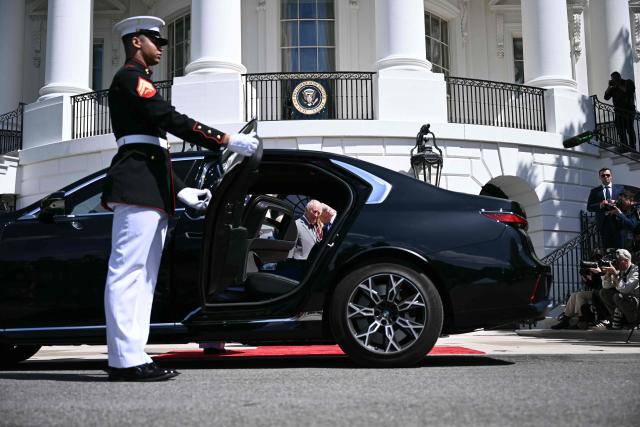 US President Donald Trump and Britain's King Charles III are seen through an open car door as they speak during a farewell ceremony on the South Lawn of the White House in Washington, DC, on April 30, 2026. King Charles III and Queen Camilla are wrapping up their visit to the United States and will head to Bermuda next. (Photo by Brendan SMIALOWSKI / AFP)