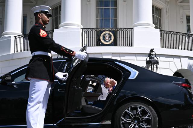 US President Donald Trump and Britain's King Charles III are seen through an open car door as they speak during a farewell ceremony on the South Lawn of the White House in Washington, DC, on April 30, 2026. King Charles III and Queen Camilla are wrapping up their visit to the United States and will head to Bermuda next. (Photo by Brendan SMIALOWSKI / AFP)