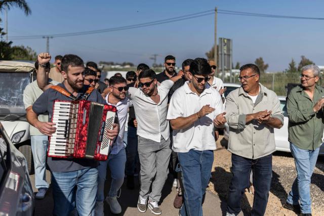People take part in a traditional wedding ceremony of the Circassian community in the northern Israeli town of Rehaniya, by the Israel border with Lebanon on April 30, 2026. (Photo by Ilia YEFIMOVICH / AFP)