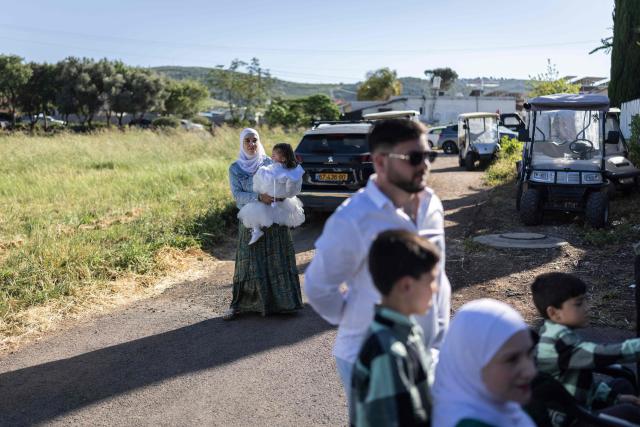 People take part in a traditional wedding ceremony of the Circassian community in the northern Israeli town of Rehaniya, by the Israel border with Lebanon on April 30, 2026. (Photo by Ilia YEFIMOVICH / AFP)
