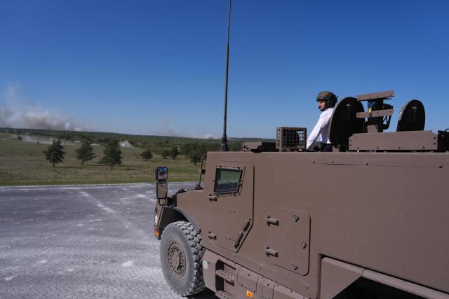 France's President Emmanuel Macron stands in a Serval armoured vehicle during a visit at the Orion 2026 military exercise of Suippes, eastern France on April 30, 2026. Troops are being deployed as part of Orion 26, a large-scale exercise launched in February which, in its fourth and final phase, currently involves up to 12,500 military personnel. (Photo by Aurelien Morissard / POOL / AFP)