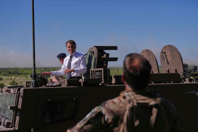 France's President Emmanuel Macron stands in a Serval armoured vehicle during a visit at the Orion 2026 military exercise of Suippes, eastern France on April 30, 2026. Troops are being deployed as part of Orion 26, a large-scale exercise launched in February which, in its fourth and final phase, currently involves up to 12,500 military personnel. (Photo by Aurelien Morissard / POOL / AFP)