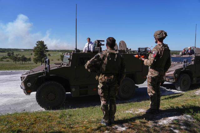 France's President Emmanuel Macron stands in a Serval armoured vehicle during a visit at the Orion 2026 military exercise of Suippes, eastern France on April 30, 2026. Troops are being deployed as part of Orion 26, a large-scale exercise launched in February which, in its fourth and final phase, currently involves up to 12,500 military personnel. (Photo by Aurelien Morissard / POOL / AFP)