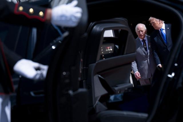TOPSHOT - US President Donald Trump and Britain's King Charles III are seen through an open car door as they speak during a farewell ceremony on the South Lawn of the White House in Washington, DC, on April 30, 2026. King Charles III and Queen Camilla are wrapping up their visit to the United States and will head to Bermuda next. (Photo by Brendan Smialowski / AFP)
