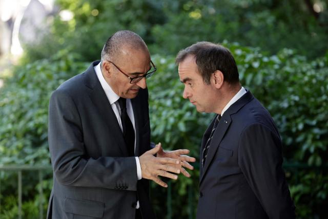 France's Prime Minister Sebastien Lecornu (R) and France's Interior Minister Laurent Nunez speak after a visit to the headquarters of the French National Agency for Secure Documents (Agence nationale des titres securises - ANTS), in Paris, on April 30, 2026. The National Agency for Secure Documents suffered a massive data breach on 15 April, 2026. The data of nearly 12 million individuals and businesses had been affected by the attack. (Photo by STEPHANE DE SAKUTIN / AFP)