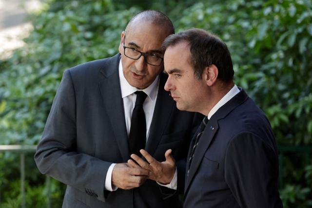 France's Prime Minister Sebastien Lecornu (R) and France's Interior Minister Laurent Nunez speak after a visit to the headquarters of the French National Agency for Secure Documents (Agence nationale des titres securises - ANTS), in Paris, on April 30, 2026. The National Agency for Secure Documents suffered a massive data breach on 15 April, 2026. The data of nearly 12 million individuals and businesses had been affected by the attack. (Photo by STEPHANE DE SAKUTIN / AFP)