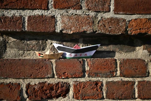 This photographs hsows paper boats on a wall during a demonstration to condemn the interception of the Global Sumud Flotilla by the Israeli army, in Turin on April 30, 2026. The Israeli navy intercepted and halted part of the Global Sumud Flotilla, a convoy of vessels bound for Gaza as it sailed in international waters west of the island of Crete. According to Israeli sources and flotilla organizers, at least twenty boats were boarded and around 175 activists were detained and transferred to Israel. (Photo by MARCO BERTORELLO / AFP)