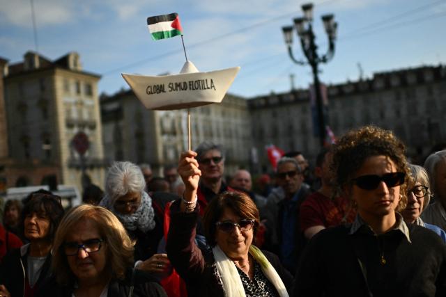A protestor holds a paper boat “Global Sumud Flotilla” during a demonstration to condemn the interception of the Global Sumud Flotilla by the Israeli army, in Turin on April 30, 2026. The Israeli navy intercepted and halted part of the Global Sumud Flotilla, a convoy of vessels bound for Gaza as it sailed in international waters west of the island of Crete. According to Israeli sources and flotilla organizers, at least twenty boats were boarded and around 175 activists were detained and transferred to Israel. (Photo by MARCO BERTORELLO / AFP)