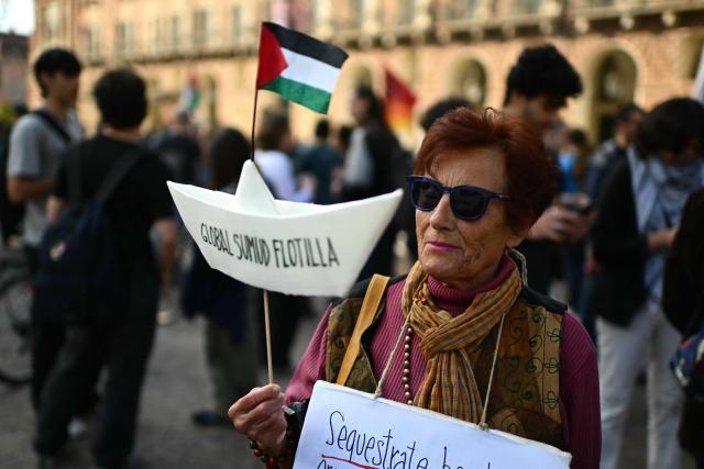A protestor holds a paper boat “Global Sumud Flotilla” during a demonstration to condemn the interception of the Global Sumud Flotilla by the Israeli army, in Turin on April 30, 2026. The Israeli navy intercepted and halted part of the Global Sumud Flotilla, a convoy of vessels bound for Gaza as it sailed in international waters west of the island of Crete. According to Israeli sources and flotilla organizers, at least twenty boats were boarded and around 175 activists were detained and transferred to Israel. (Photo by MARCO BERTORELLO / AFP)