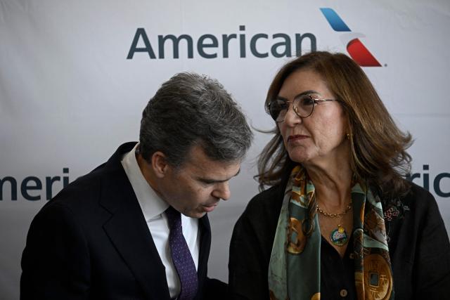 Head of the US diplomatic mission in Venezuela John Barrett and Venezuela’s Transport Minister Jacqueline Faria deliver a press conference at Simon Bolivar International Airport in La Guaira, La Guaira state, Venezuela, ahead of the arrival of a flight from Miami on April 30, 2026. The first direct flight between the United States and Venezuela in seven years took off on April 30, a new sign of a thaw after Washington deposed leftist leader Nicolas Maduro. (Photo by Federico PARRA / AFP)