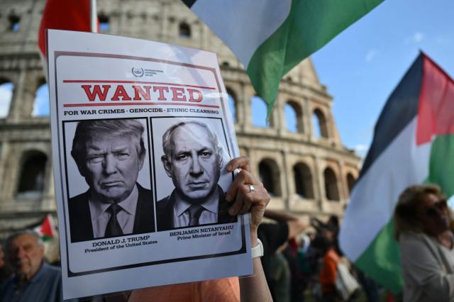 A protester holds a placard with US President Donald Trump and Israel’s Prime Minister Benjamin Netanyahu (R) during a rally in support of the Freedom Flotilla in front of the Colosseum in Rome on April 30, 2020. The Israeli navy intercepted and halted part of the Global Sumud Flotilla, a convoy of vessels bound for Gaza as it sailed in international waters west of the island of Crete. According to Israeli sources and flotilla organizers, at least twenty boats were boarded and around 175 activists were detained and transferred to Israel. (Photo by Alberto PIZZOLI / AFP)