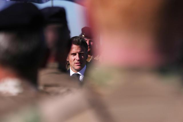 France's President Emmanuel Macron (C) speaks with soldiers during the Orion 2026 military exercises in Suippes, eastern France on April 30, 2026. Troops are being deployed as part of Orion 26, a large-scale exercise launched in February which, in its fourth and final phase, currently involves up to 12,500 military personnel. (Photo by Aurelien Morissard / POOL / AFP)