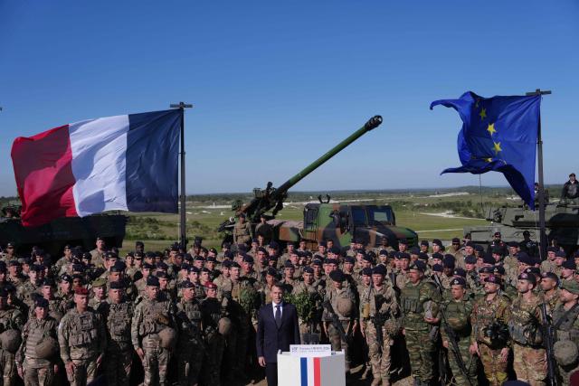 France's President Emmanuel Macron (C) speaks with soldiers during the Orion 2026 military exercises in Suippes, eastern France on April 30, 2026. Troops are being deployed as part of Orion 26, a large-scale exercise launched in February which, in its fourth and final phase, currently involves up to 12,500 military personnel. (Photo by Aurelien Morissard / POOL / AFP)