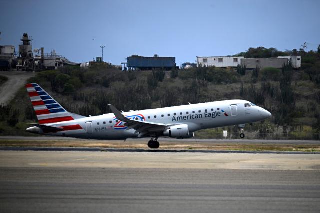 An American Eagle aircraft, operating a regional flight for American Airlines, lands at Simon Bolivar International Airport in La Guaira, La Guaira state, Venezuela on April 30, 2026. The first direct commercial flight between the United States and Venezuela in seven years arrived in Caracas on April 30, marking a new sign of a thaw after Washington deposed leftist leader Nicolas Maduro and resumed diplomatic relations following years of tension. (Photo by Federico PARRA / AFP)