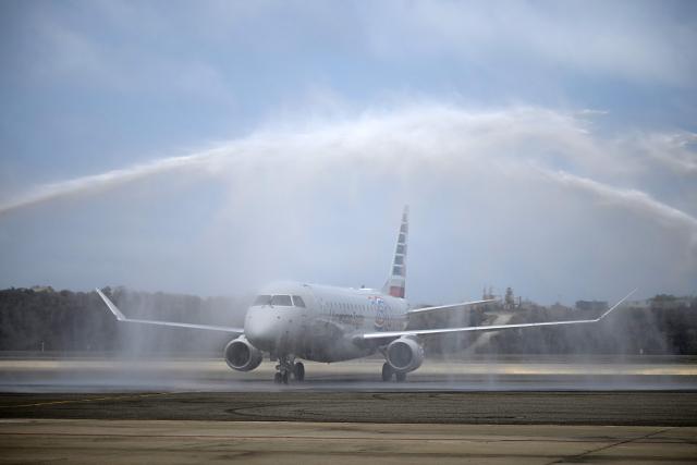 An American Eagle aircraft, operating a regional flight for American Airlines, is sprayed with water after landing at Simon Bolivar International Airport in La Guaira, La Guaira state, Venezuela on April 30, 2026. The first direct commercial flight between the United States and Venezuela in seven years arrived in Caracas on April 30, marking a new sign of a thaw after Washington deposed leftist leader Nicolas Maduro and resumed diplomatic relations following years of tension. (Photo by Federico PARRA / AFP)