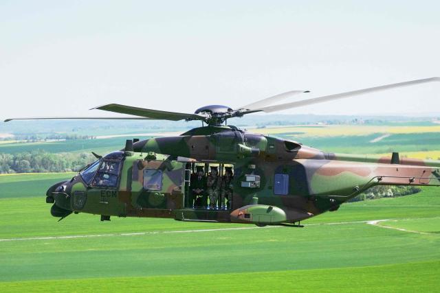 France's President Emmanuel Macron (L) boards a NH90 Caiman helicopter during the Orion 2026 military exercises at a camp in Suippes, eastern France, on April 30, 2026. Troops are being deployed as part of Orion 26, a large-scale exercise launched in February which, in its fourth and final phase, currently involves up to 12,500 military personnel. (Photo by Aurelien Morissard / POOL / AFP)