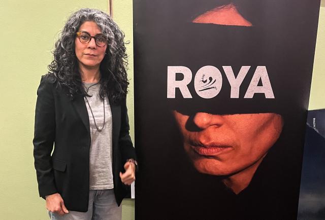 Iranian film director Mahnaz Mohammadi poses next to the poster of her film "Roya" on April 29, 2026 at a cinema in Berlin, before the preview screening of the movie, during an interview with AFP. Already shown at the Berlinale film festival 2026 in the Panorama section in February, the film will be released in German cinemas on May 7, 2026. The film crew of "Roya," that is about the traumas endured by a political prisoner in Evin Prison in Tehran, called on audiences at the film’s German premiere to “not forget” the Iranian people. “The existence of the Iranian people today is like that of Roya,” the film’s heroine, “it’s not livable,” director Mahnaz Mohammadi, 51, summed up in an interview with AFP. (Photo by Pierrick YVON / AFP)