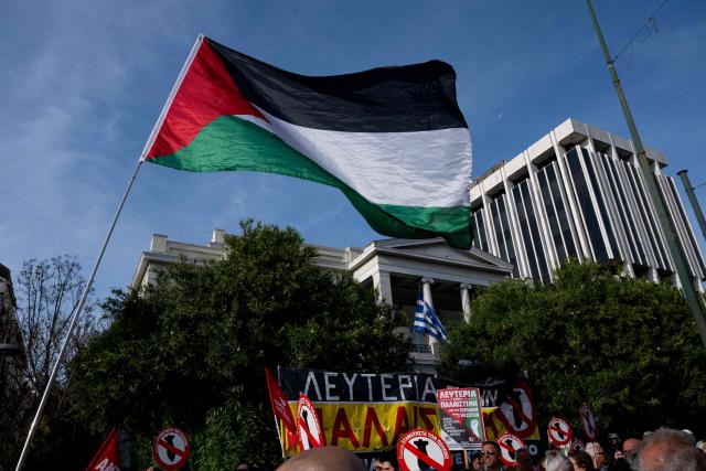 Protesters hold banners and wave Palestinian flags as they gather outside the Ministry of Foreign Affairs to protest against the detention of members of the Global Sumud Flotilla off the Greek island of Crete by the Israeli navy, in Athens on April 30, 2026. The Israeli navy intercepted and halted part of the Global Sumud Flotilla, a convoy of vessels bound for Gaza as it sailed in international waters west of the island of Crete. According to Israeli sources and flotilla organizers, at least twenty boats were boarded and around 175 activists were detained and transferred to Israel. (Photo by Aggelos NAKKAS / AFP)