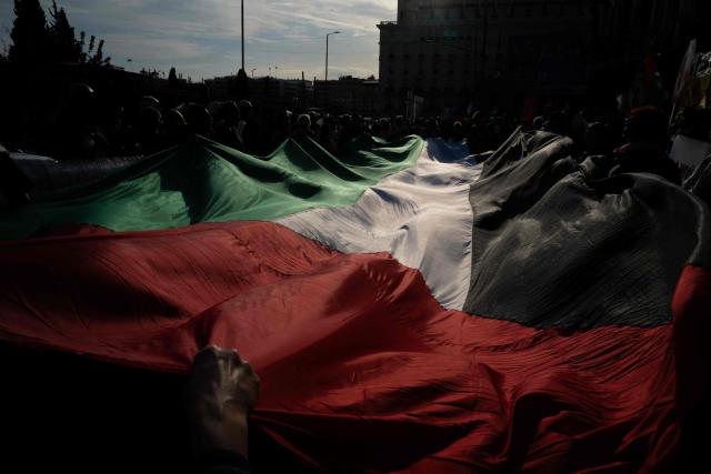 Protesters wave a giant Palestinian flag as they gather outside the Ministry of Foreign Affairs to protest against the detention of members of the Global Sumud Flotilla off the Greek island of Crete by the Israeli navy, in Athens on April 30, 2026. The Israeli navy intercepted and halted part of the Global Sumud Flotilla, a convoy of vessels bound for Gaza as it sailed in international waters west of the island of Crete. According to Israeli sources and flotilla organizers, at least twenty boats were boarded and around 175 activists were detained and transferred to Israel. (Photo by Aggelos NAKKAS / AFP)