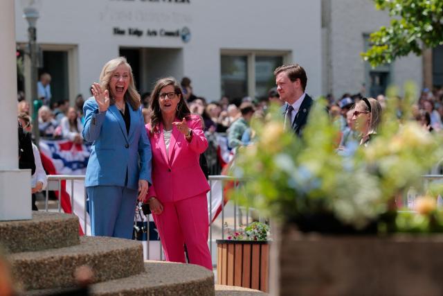 Governor Abigail Spanberger (L) and Mayor of Front Royal Lori A. Cockrell (C) wave as they wait for Britain's King Charles and Queen Camilla to appear during a community parade and block party in Front Royal, Virginia, on April 30, 2026. (Photo by Kylie Cooper / POOL / AFP)