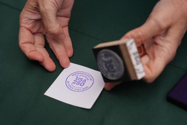 A National Park stamp is seen before Britain's King Charles III visits Shenandoah National Park in Front Royal, Virginia, on April 30, 2026. (Photo by Julia Demaree Nikhinson / POOL / AFP)