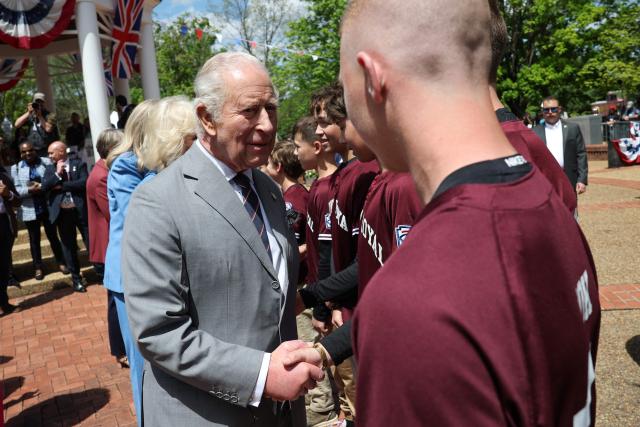 Britain's King Charles and Queen Camilla greet the Virginia state champions Front Royal Little League baseball team as they arrive for a parade and block party in Front Royal, Virginia, on April 30, 2026. (Photo by Win McNamee / POOL / AFP)